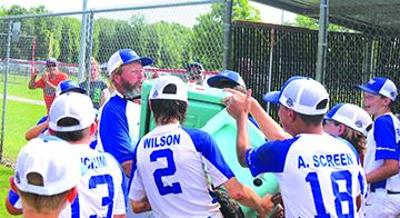 Melrose Babe Ruth 12-and-under All-Star baseball players try to give manager Dale Yarbrough (middle) a water cooler bath after winning the Small States championship in Fort White on Monday. (MARK BLUMENTHAL / Palatka Daily News)