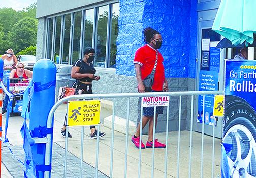 People comply with the new mandatory face-covering rule at Walmart in Palatka on Monday, except for one woman who said she was only returning her motorized cart to the store. 