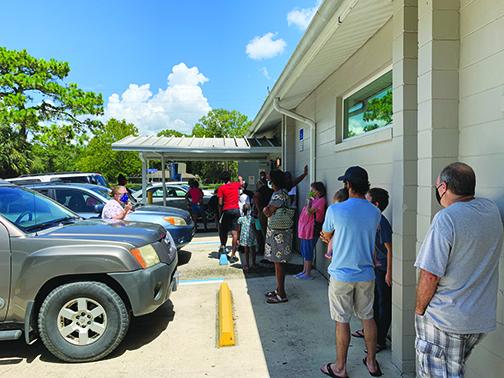 Residents line up for COVID-19 testing outside the Interlachen Community Center last week.