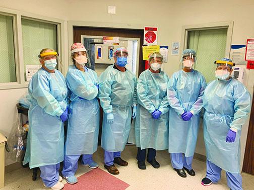 Dr. Richard Feibelman, third from left, a critical care doctor at Putnam Community Medical Center, and the hospital intensive care unit team wear their protective gear when working with COVID-19 patients.