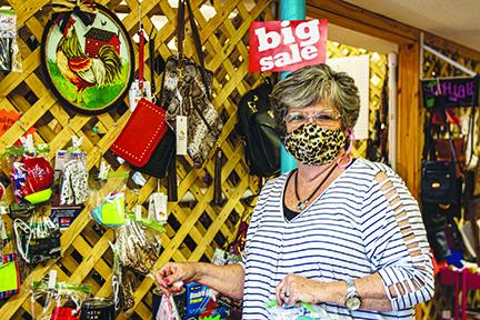 Lynda Williams, owner of Sassy Snaps and Blyng in Rivertown Suites Marketplace in Palatka, shows off the many masks she’s made during the coronavirus pandemic and said making masks kept her business going.