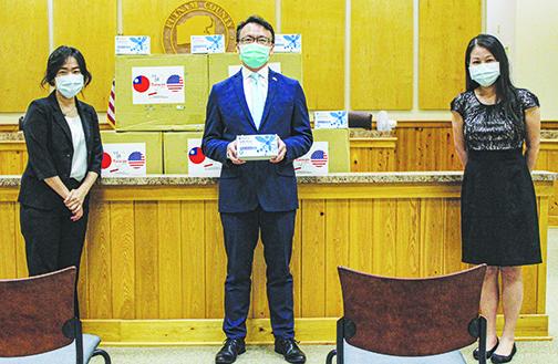 Representatives from the Taipei Economic and Cultural Office in Miami present 10,000 masks from Taiwan donated Wednesday to help Putnam County. From left, Director Sara Chen, Director General David Chien and Claire Chen gave away the masks, saying they were happy to be able to help.