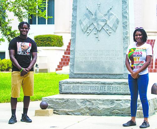 Protest organizers Tevel Adams and Dar’Nesha Leonard stand in front of the Confederate statue at the Putnam County Courthouse on Thursday.