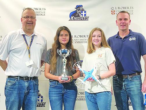 Q.I. Roberts Junior-Senior High students Paige Griner, center left, and Sofia Jolley, center right, placed second in Embry-Riddle Aeronautical University’s Drone Olympics and are standing with aeronautics instructor Daniel Lewandowski, left, and Q.I. Roberts Principal Joe Theobold.