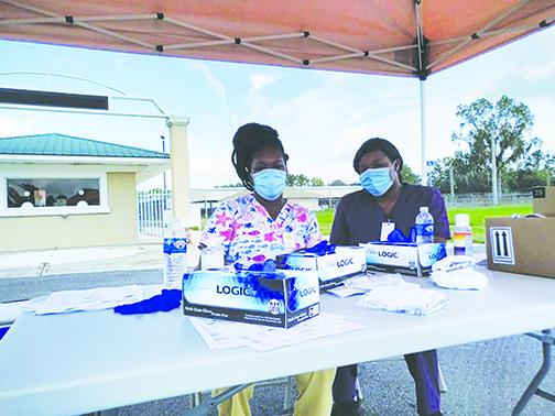 Health officials wait to test residents Sunday afternoon during the free drive-thru COVID-19 testing Sunday at the Putnam County Fairgrounds. 
