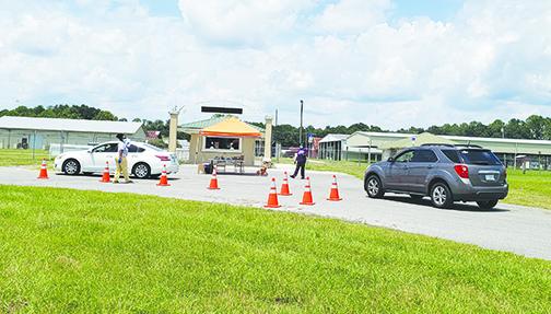 Health officials check in residents Sunday afternoon for free drive-thru COVID-19 testing at the Putnam County Fairgrounds. Drive-thru testing is scheduled again 8 a.m. – 1 p.m. today at the fairgrounds.