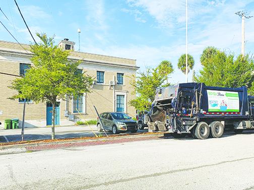 A Palatka sanitation truck is parked outside City Hall on Monday while workers talk to City Manager Don Holmes about receiving raises.