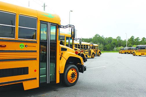 Buses are lined up at the Putnam County School District’s bus depot Thursday afternoon. School buses will be stocked with sanitizer, and students and bus drivers must wear masks as part of COVID-19 precautions.