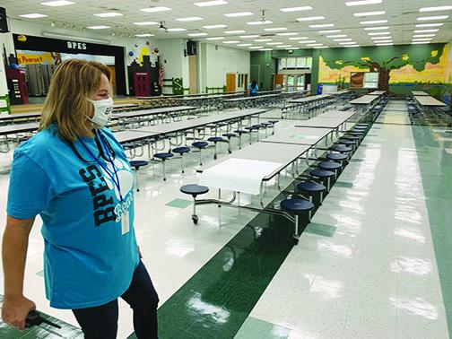 Browing-Pearce Elementary School Principal Beth Nelson inspects the school’s cafeteria. Because of COVID-19, Nelson said kindergarteners will have lunch delivered and fifth-graders would not eat in the cafeteria. Every other seat in the cafeteria is marked off with a sticker for social distancing.