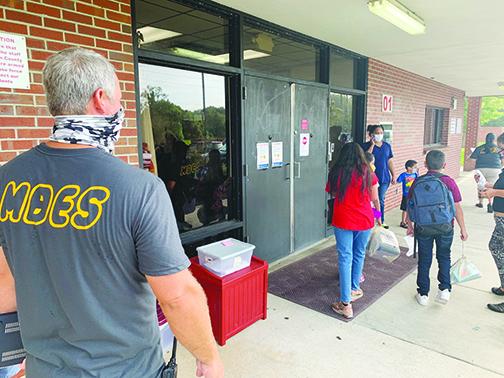 Middleton-Burney Elementary School Principal Rodney Symonds watches as students, parents and staff enter in front of the school’s main office Monday morning.