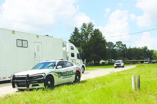 The Putnam County Sheriff’s Office mobile command unit is parked outside a Melrose home Wednesday after authorities discovered the bodies of two young brothers inside their home.