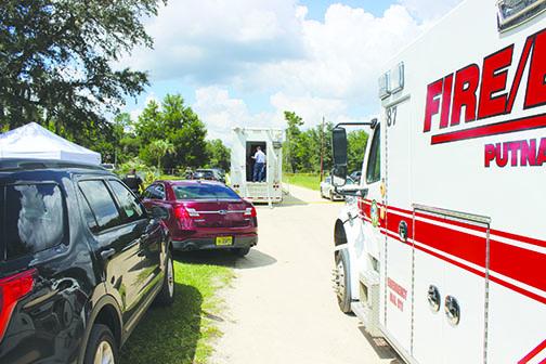 The Putnam County Sheriff’s Office stations its mobile command unit and tents for deputies in Melrose, where to teenagers were found dead Wednesday morning.