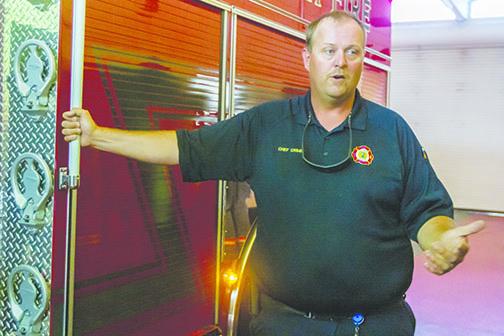 Palatka Fire Chief J.R. Grimes stands next to one of the station’s fire trucks last year.