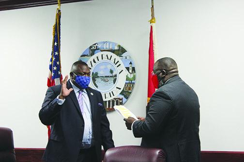 Palatka City Commissioner Justin Campbell, right, swears in Mayor Terrill Hill as the new president of the Florida League of Mayors on Thursday afternoon.