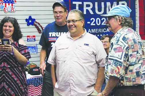 Paul Adamczyk, center, celebrates with supporters at the Republican Party headquarters in Palatka on Tuesday.
