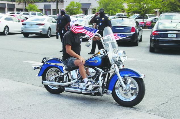 A man leaves the government complex on a motorcycle Saturday afternoon.