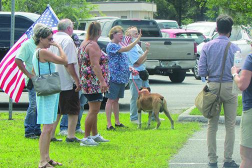 A woman disagrees to a speaker's remarks during Saturday's protest at the Putnam County Government Complex.