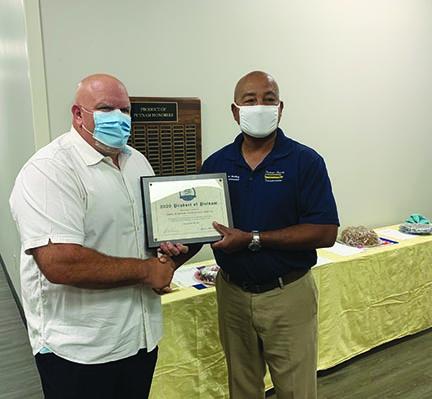Eddie Parcher, left, stands next to Assistant Superintendent for Support Services Thomas Bolling to accept his Product of Putnam plaque. Due to the COVID-19 pandemic, the school district was unable to recognize the honorees together.