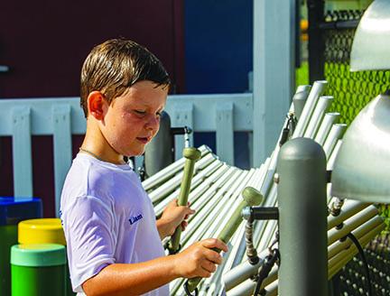 Liam Rawls, 6, plays a tune on the xylophone at the park.