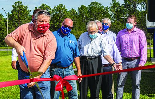 County officials and Rotary Club members cut the ribbon to officially open the park.