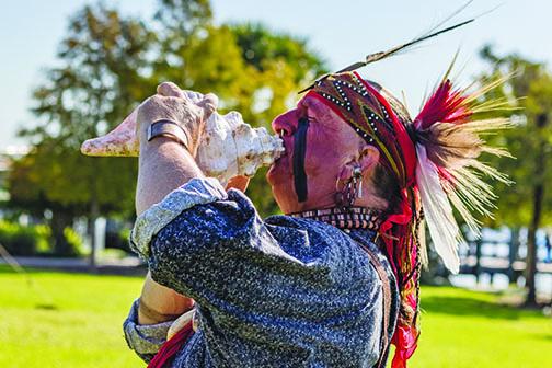 The Long Warrior blows into a conch shell to start the Bartram Frolic learning experience for students last September.