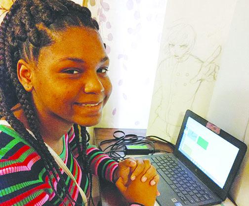 Toriyanna Harris, a 10th-grader at Q. I. Roberts Junior-Senior High School, works on an assignment on her computer.