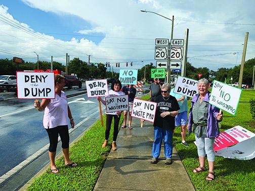 Mary Grace Sheptock, Sue Paper, Mary Lou Dawson and Barbara Smith protest against a proposed landfill in Interlachen on Wednesday.