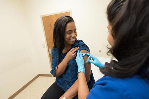 A health care provider places a bandage on the injection site of a patient who received an influenza vaccine. The Centers for Disease Control and Prevention recommends everyone 6 months of age and older get a flu vaccine every year.