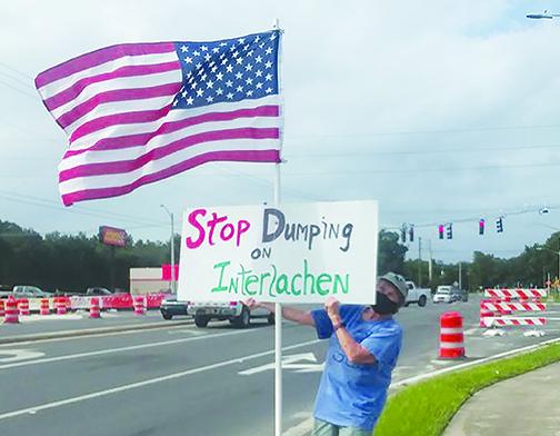 Seeking support from State Road 20 motorists, Kate Gallagher protests Waste Pro expanding its Interlachen operations.
