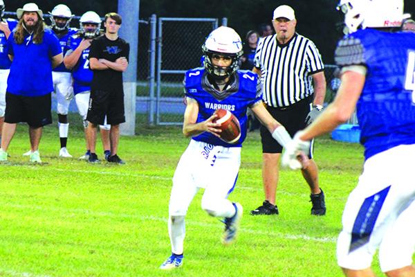 Peniel Baptist Academy quarterback Lucas Chapman scrambles to score on a 10-yard touchdown in the first quarter of Friday night’s game against Gainesville Christian at Theobold Sports Complex. (MARK BLUMENTHAL / Palatka Daily News
