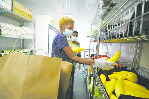 A volunteer for Feeding Northeast Florida prepares food for one of the group’s Corner Market locations in Jacksonville, where they distribute free food to people in need.