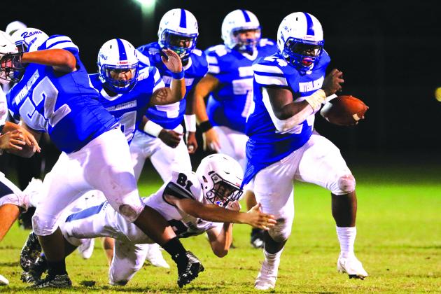 Interlachen’s D.J. Polite busts a tackle attempt by Parrish Community High’s James Keen for yards in the Rams’ win on Sept. 18. (GREG OYSTER / Special To The Daily News)