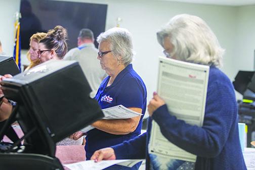 On Friday, election workers Dorothy Cooper and Carlene Mims insert test ballots into machines used in Putnam County elections