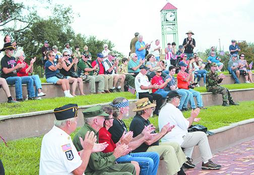 Local residents attend a previous Veterans Day Ceremony immediately after the parade. This year’s parade was canceled out of caution over COVID-19.