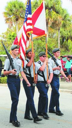 Members of the Palatka High School JROTC carry the American and Florida flags along St. Johns Avenue in Palatka in a previous Veterans Day Parade.