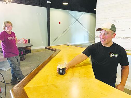 Azalea Brewing Co. facilities manager Rod Wies, left, and head brewer Eli Miranda show off some of the beer the company plans to sell when it opens.