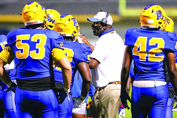 Palatka High School football coach Willie Fells talks and shows strategy with his players during their loss to Live Oak Suwannee on Oct. 9. (GREG OYSTER / Special To The Daily News)