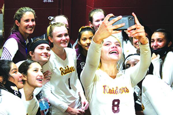 Veronica Ramirez holds her phone camera to take one final selfie with her Crescent City High volleyball teammates and coaches after losing in the Region 4-1A semifinal Tuesday night to Trenton. (MARK BLUMENTHAL / Palatka Daily News)