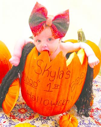 Skyla Chausse is celebrating her first Halloween by taking a bite out of her pumpkin. 