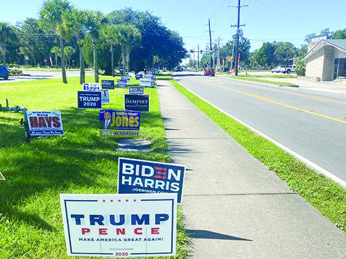 Campaign signs line the lawn in front of the Elections Office in Palatka on Friday, the penultimate day of early voting.