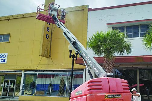 Workers prepare the old JCPenney building in downtown Palatka for a new coat of paint.