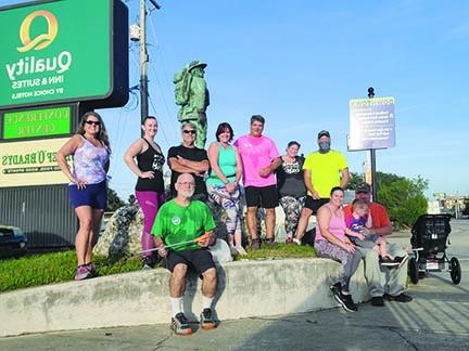 The Morning Maniacs take a rest at Memorial Bridge after cleaning it up and getting a jog in at sunrise earlier this year.