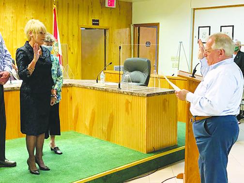 Recently-elected Crescent City Mayor Michele Myers is sworn in to office Monday night at City Hall as Clerk of Courts Tim Smith conducts the ceremony.