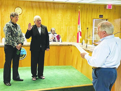 Newly-elected Crescent City Commissioner Cynthia Jo Burton get sworn in Monday before taking part in her first city commission meeting.  