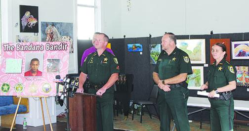 At a press conference Tuesday, Putnam County Sheriff Gator DeLoach – standing with Bradford County Sheriff Gordan Smith and Clay County Sheriff Michelle Cook – announces the arrest of Noe Cruz, who is accused of robbing five businesses in three counties.