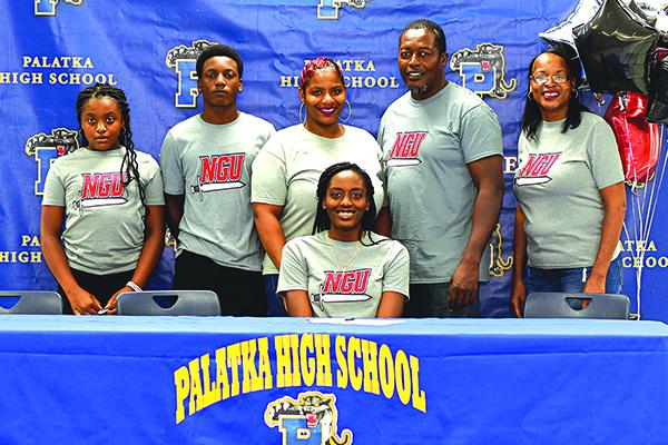 Amareya Turner smiles after signing her letter of intent to play next year at North Greenville University. Enjoying the moment behind her, from left, are  her sister Ke’mareya, brother Tony, mother Latrise, father Kevin and grandmother Stephanie McRae Robinson. (Submitted photo / Palatka High School)