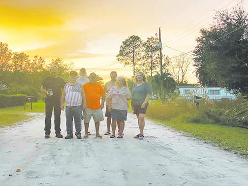Residents of St. Johns Riverside Estates stand on Creekside Road after county workers grated the street.