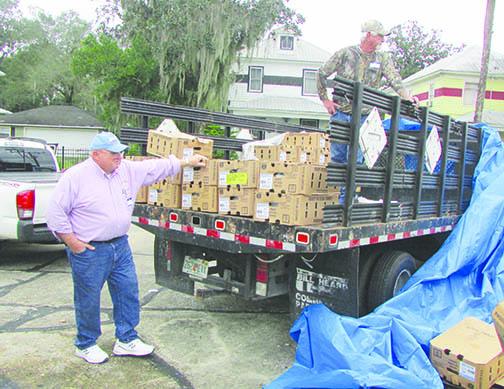 Rudy Howard, pastor of Providence Baptist Church in Bardin, left, helps Glenn Thomas unload a truck full of frozen turkeys Thursday at the St. Johns River Baptist Association headquarters in Palatka.