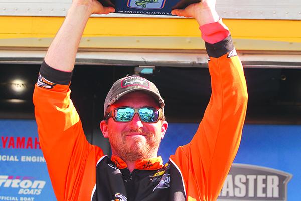 Paul Mueller of Naugatuk, Conn. holds up the championship trophy after winning the Bassmaster Elite at the St. Johns River championship on Feb. 10. (WAYNE SMITH / Palatka Daily News)
