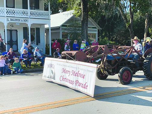 A festive tractor rides in the 2019 Melrose Christmas Parade. On Saturday, the Melrose Patriots are hosting Christmas festivities complete with Santa Claus and crafts.